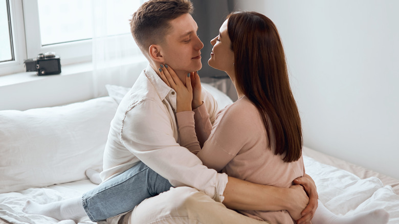 couple cuddling on bed