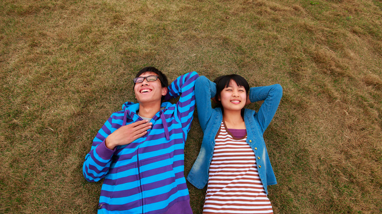 couple lying on grass