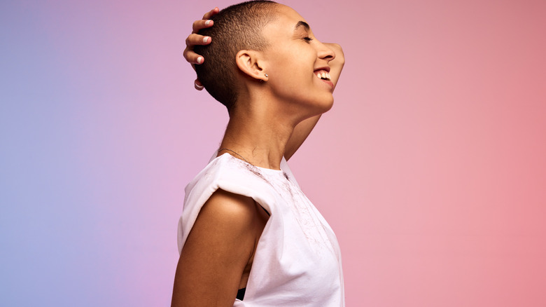 woman smiling with a pink and purple background