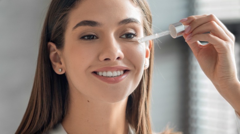 female applying skincare