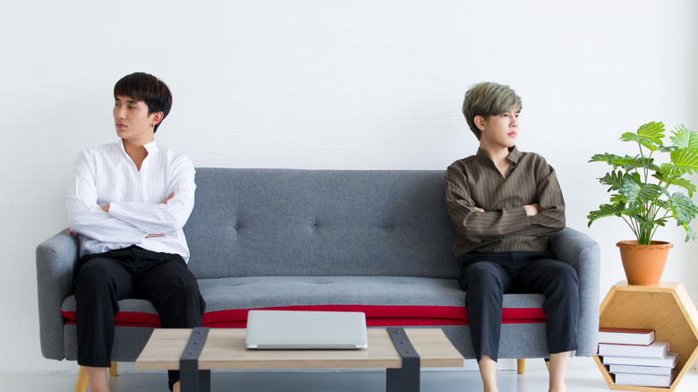 Couple on opposite couch ends