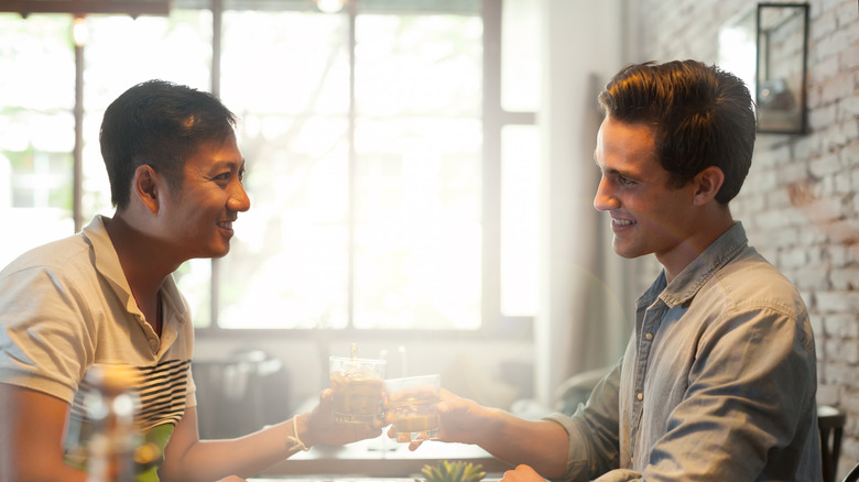 Two men share a toast