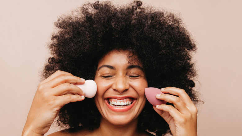 woman blending makeup