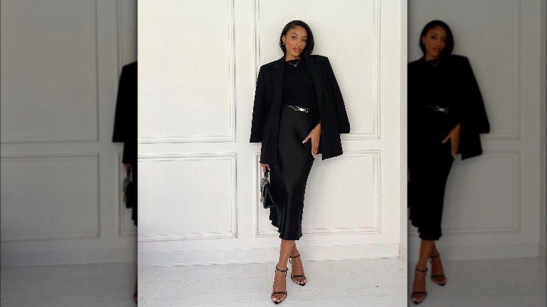 A woman wearing a silk midi skirt