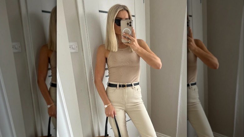 A woman wearing a beige tank top