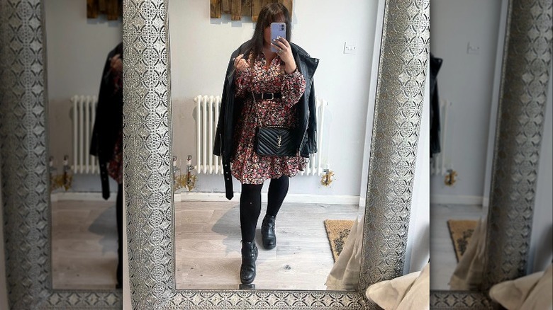 A woman wearing a floral dress and boots