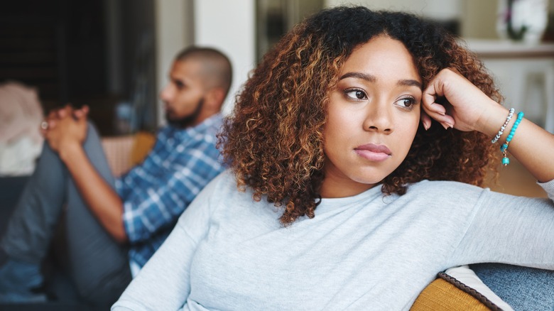 unhappy woman next to man