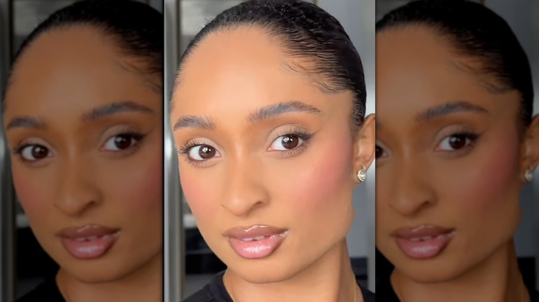 Woman putting on blush