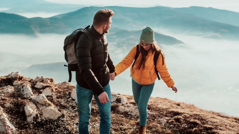Man and woman hiking uphill