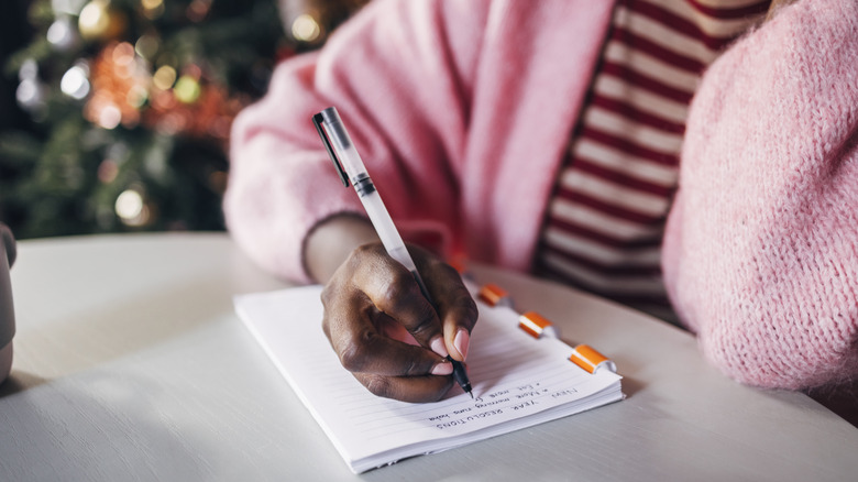 Woman writing in a journal