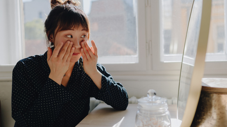 Woman applying eye cream