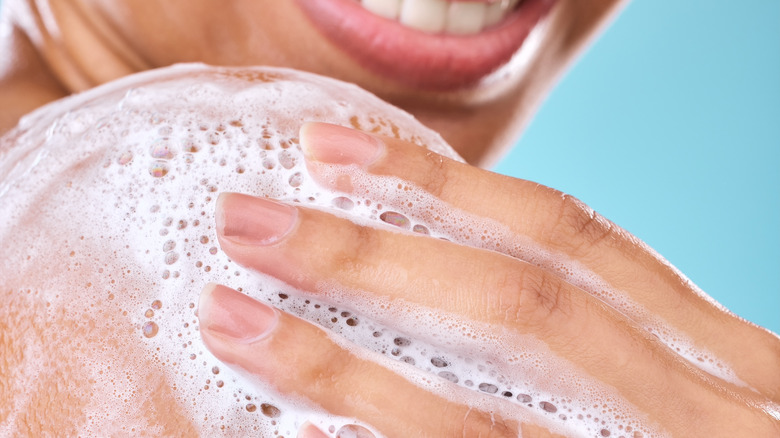 woman applying body wash