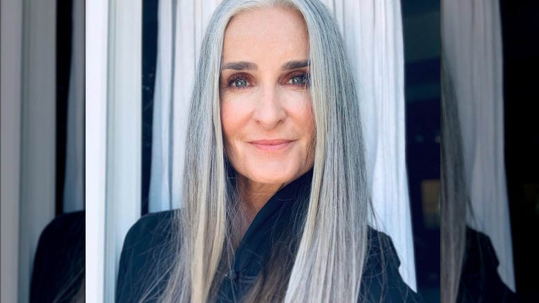 Gray-haired woman in blue top