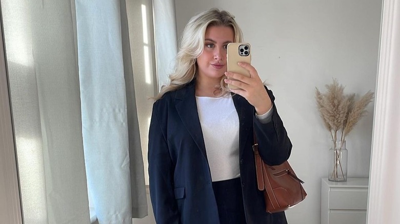 Woman in navy blazer with blond hair