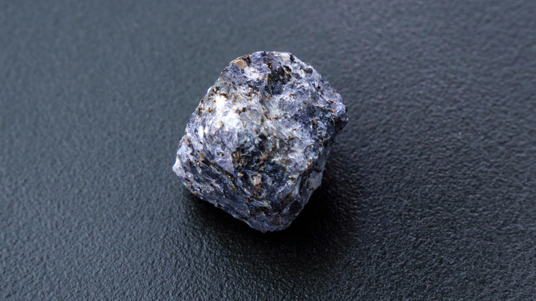Raw iolite on blue background