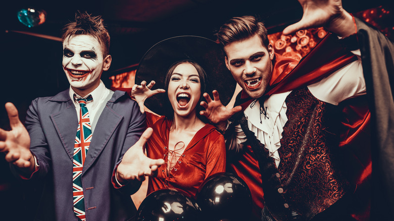 Smiling men and woman in costume