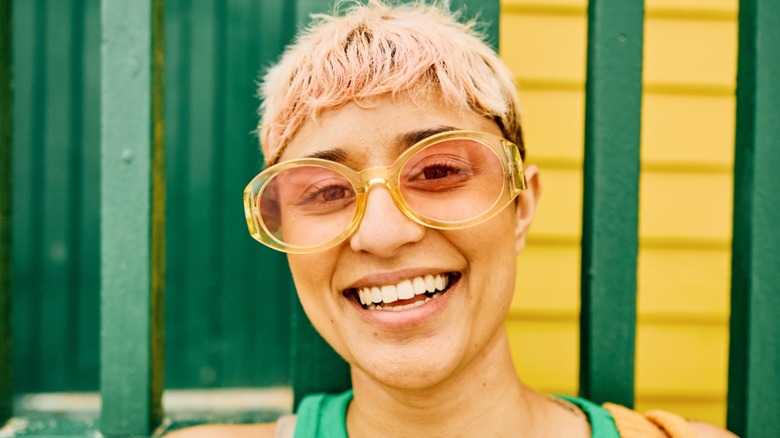 person with warm-medium skin wearing yellow glasses