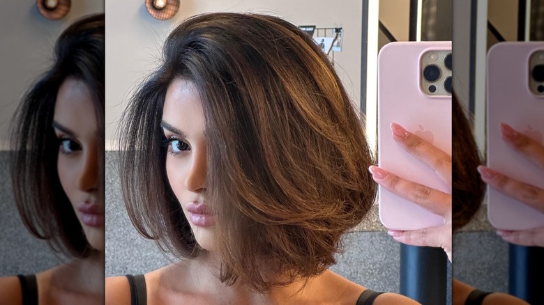 brunette woman taking selfie