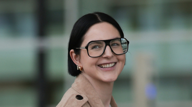 Woman with a blunt bob wearing glasses