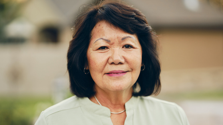 An older woman with a blunt bob and bangs