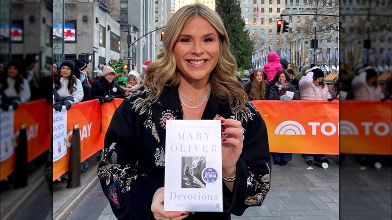 Jenna Bush Hager posing with a copy of "Devotions" by Mary Oliver.