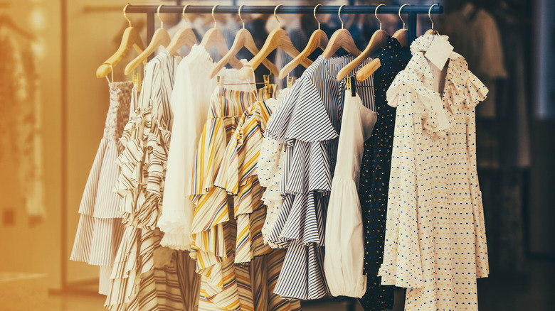 luxury clothes hanging in closet