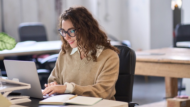 Woman does research on laptop