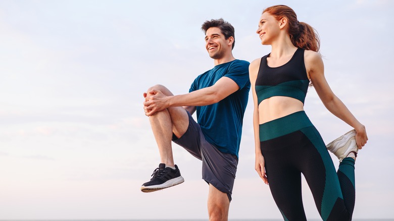 Man and woman stretching 