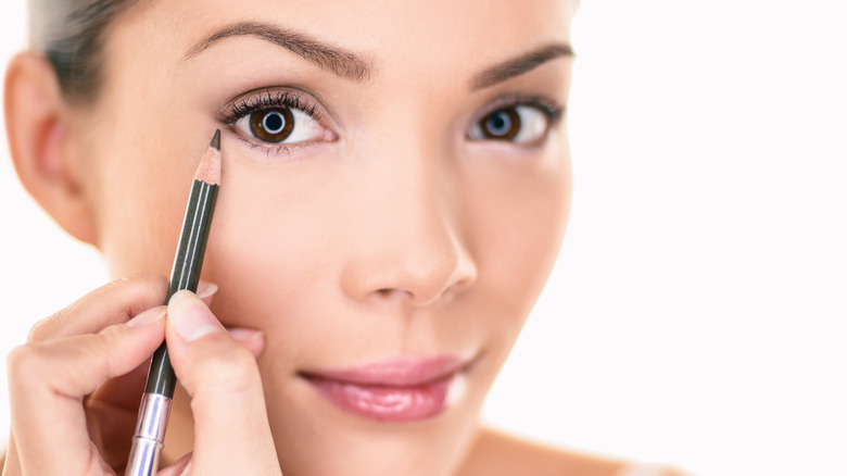 Woman draws a pencil line