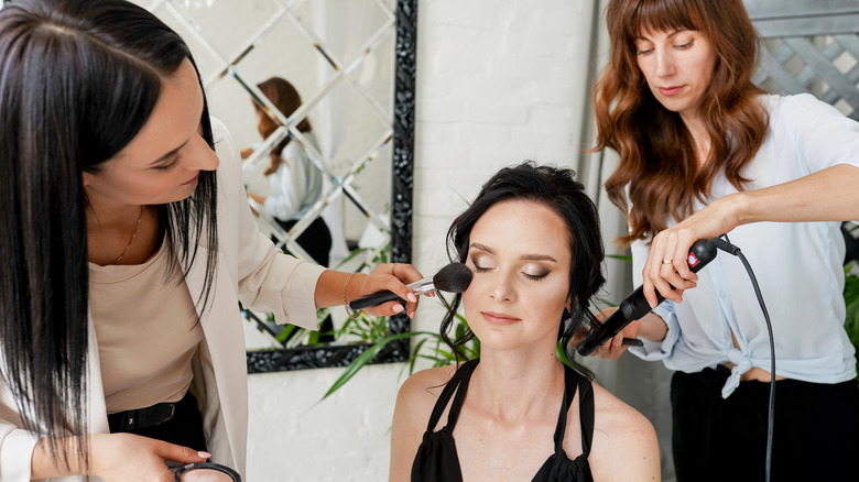 woman getting hair and makeup done
