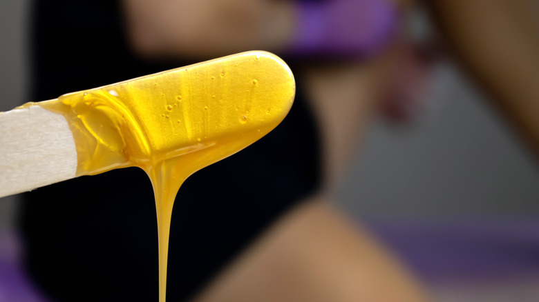 body wax on tongue depressor