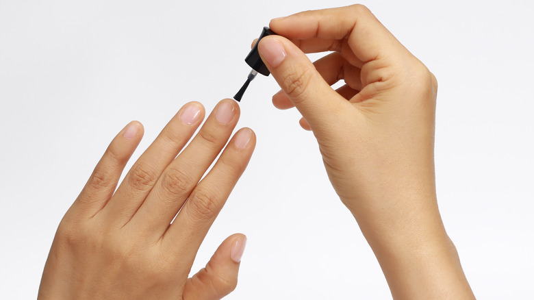 person applying clear top coat