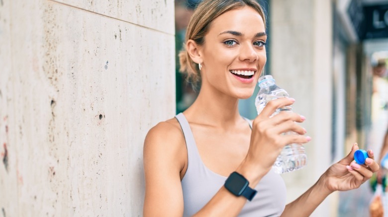 Woman drinking from water bottle