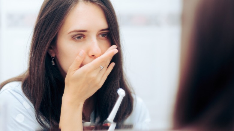 Woman covering mouth with hand