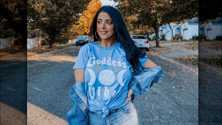 Person wearing denim jacket off shoulder