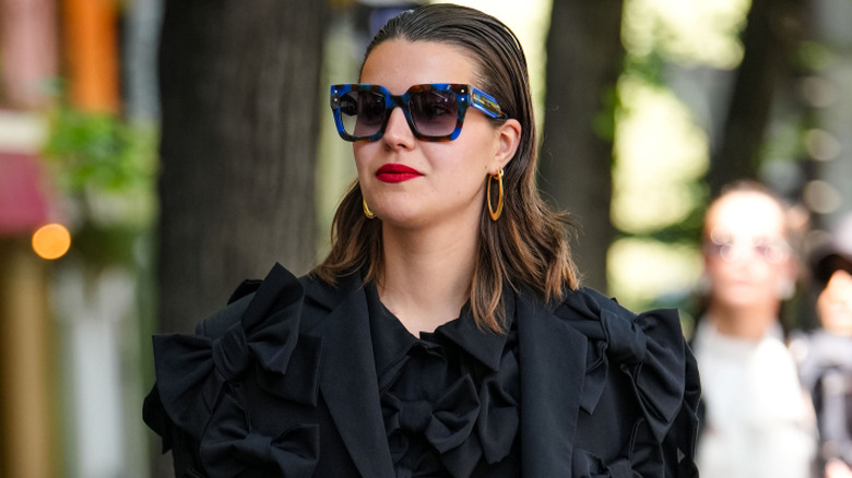 Woman wearing oversized sunglasses