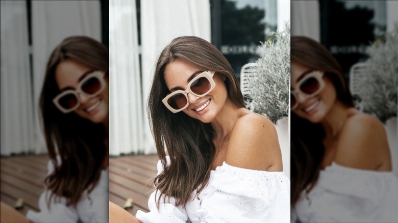 Woman wearing white shirt and glasses