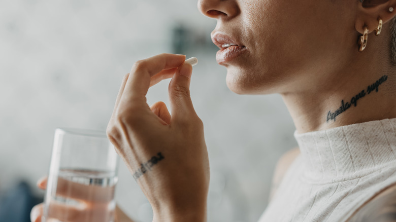 woman taking a pill