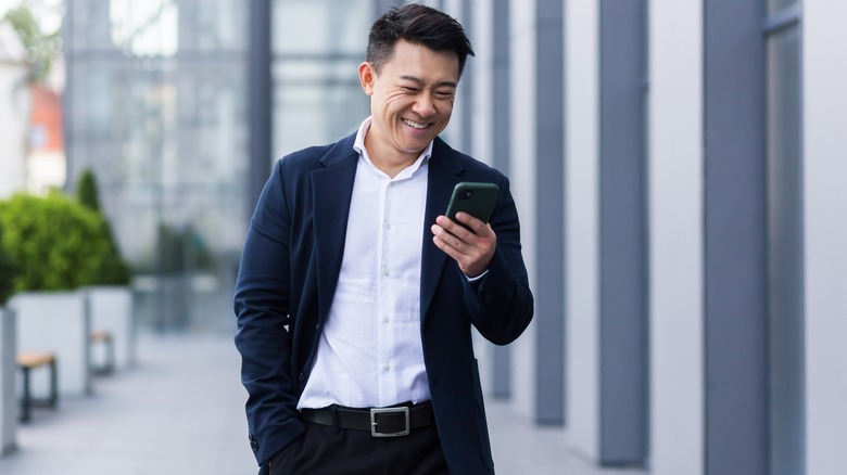 Man with blazer over tucked in shirt