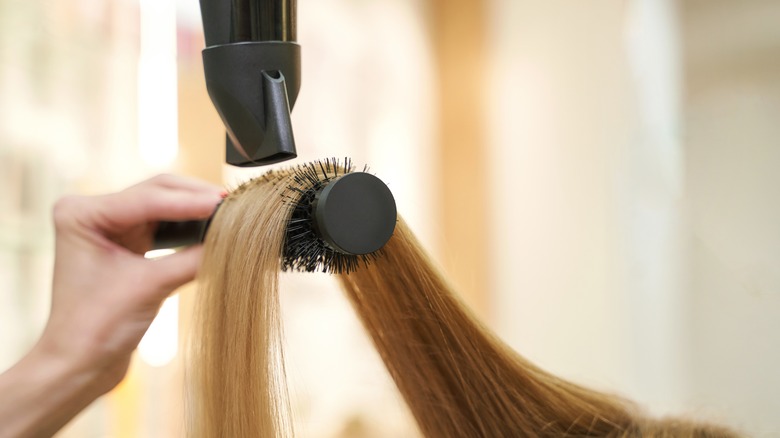 Styling hair with blowdryer