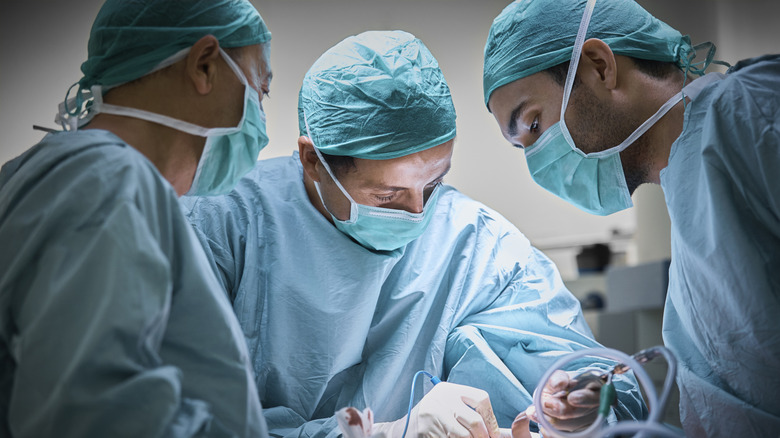 A team of plastic surgeons performing surgery in the theater