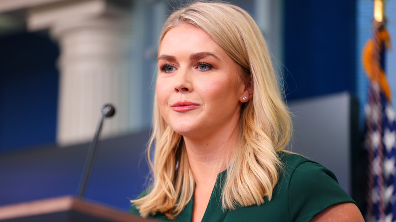 Karoline Leavitt speaks at a podium during a press meeting