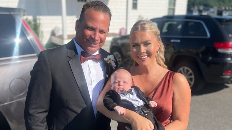 Karoline Leavitt smiling with her husband, Nicholas Riccio, and their son