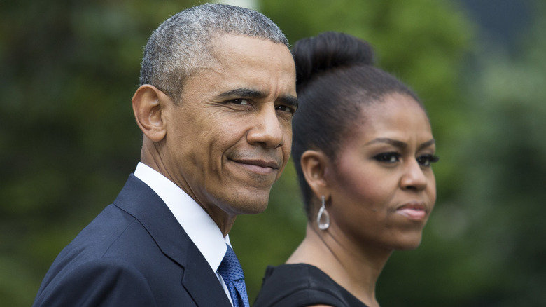 Closeup of Barack and Michelle Obama walking outside.