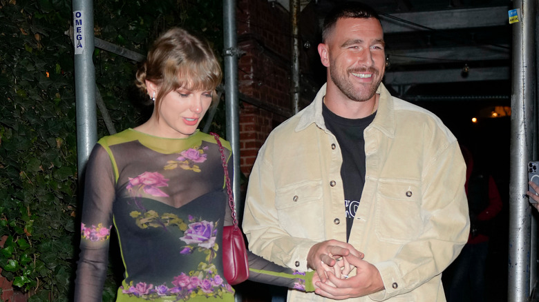 Taylor Swift and Travis Kelce holding hands in 2023.