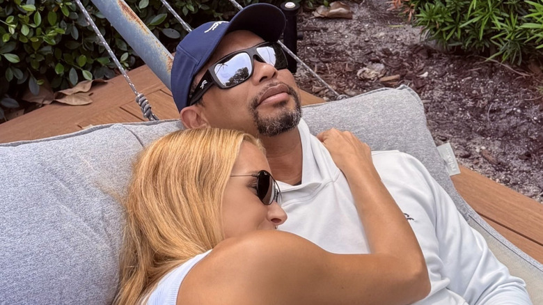 Tiger Woods and Vanessa Trump cuddling in a hammock.