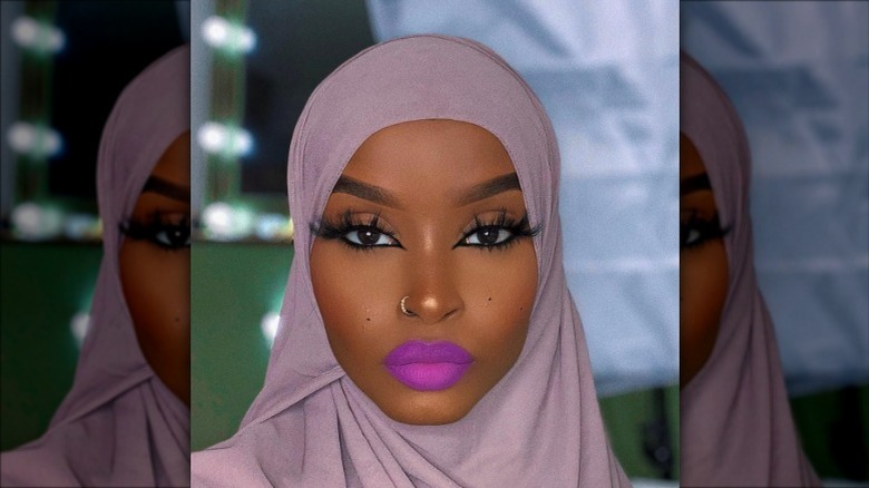 Woman with bright purple lipstick