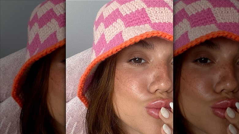 woman wearing pink checkered bucket hat