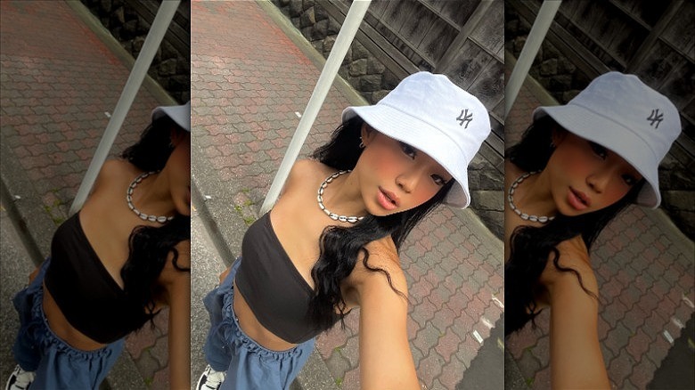 woman wearing white new york yankees bucket hat