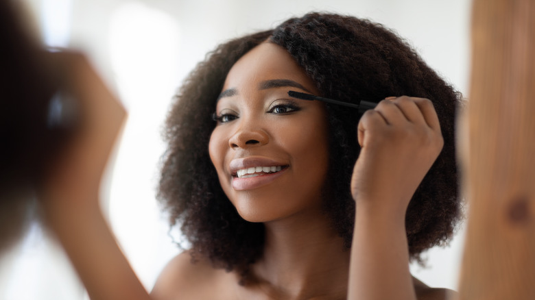 Woman applying mascara 